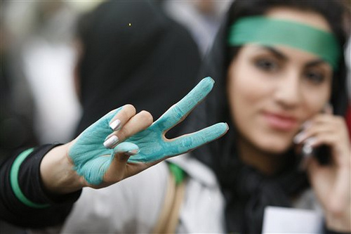 Iranian woman protesting green fingers