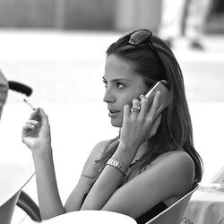 Glamorous woman cell phone cigarette sunglasses