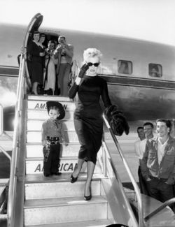 Marilyn Monroe disembarking with little cowboy